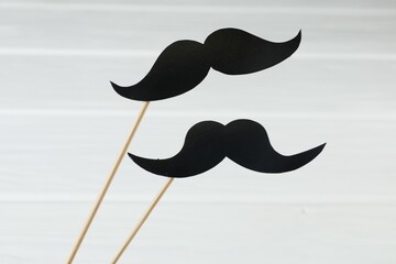 Fake paper mustaches party props on white background