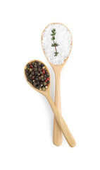 Salt with fresh thyme and peppercorns in wooden spoons isolated on white, top view