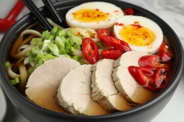Delicious ramen in bowl on table, closeup. Noodle soup