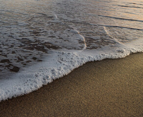 sea caressing sand from the beach of an exotic island