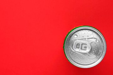 Energy drink in wet can on red background, top view. Space for text