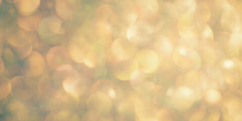 Yellow and green blurred background. Defocus lights with glitter.