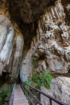 Walkway and scenic rock formations at the entrance to the Diamond Cave (Tham Phra Nang Nai) in Railay, Krabi, Thailand.
