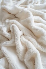 A white blanket laid out on a bed, perfect for home decor