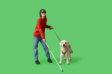 Blind woman with guide dog on green background