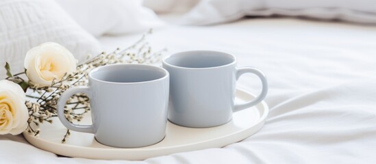 Two cups of hot coffee placed on a tray, accompanied by fresh flowers in a delightful setting