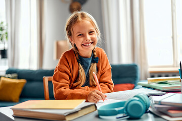 Advantages of remote education. Cheerful elementary student learning new topics in domestic...
