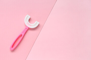 Children's toothbrush on pink background