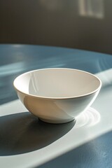 Fototapeta na wymiar A simple white bowl on a table, perfect for food and kitchen concepts