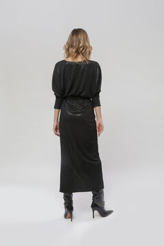 Serie of studio photos of young female model wearingblack maxi dress	
