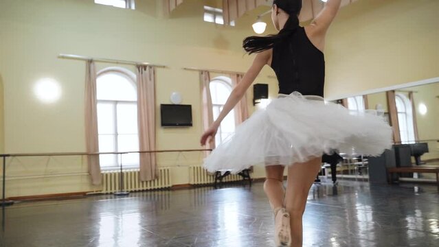Beautiful ballerina in pointe makes pirouette in slow motion