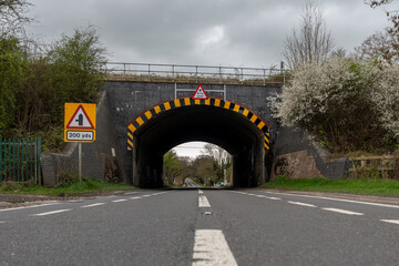 Low bridge ahead warning sign on country road