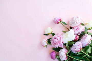 Beautiful fresh pink and white peony flowers bouquet on pink table, top view and flat lay background - obrazy, fototapety, plakaty