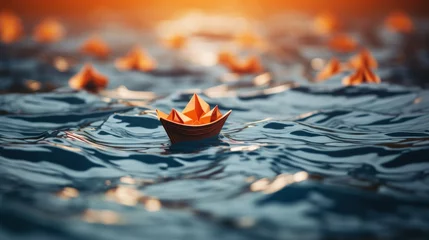 Foto op Canvas An orange paper boat is floating on the water © JH45