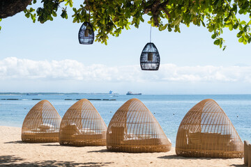 Stylish beach loungers for relaxing near the coastline, on the hotel grounds among the greenery.