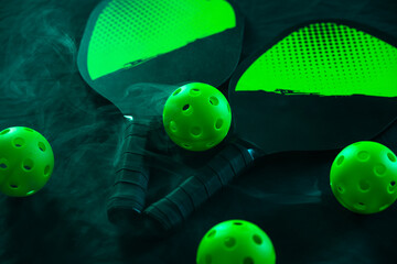 Pickleball game set. Rackets and balls on the court. Copy space. Sports background.