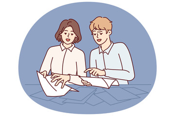 Man and woman are standing near table sorting through business documents in search right letter from partners or tax notice. Guy and girl studying contracts from large number pages
