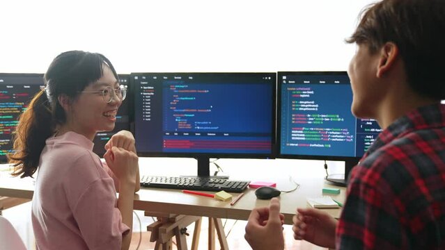 Back end software developer engineer for computer programming working together on debugging writing computing code, solving complex algorithms display on monitor in office. Burgeoning