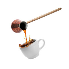 Pouring freshly brewed aromatic coffee from turkish pot into cup. Objects in air on white background