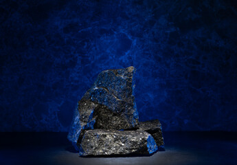 textured stone for the podium black granite with blue backlight for product presentation
