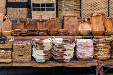 Stack of handmade rattan baskets on a shelf sold on a market stall - 773578114
