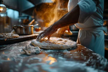Foto auf Glas The hands of a skilled chef as they expertly prepare a fresh pizza dough. Flour dusts the surface and the chef’s arms, conveying the authenticity of the traditional pizza-making process. © Peeradontax