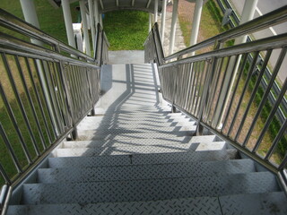 covered steel stairs descending to ground level