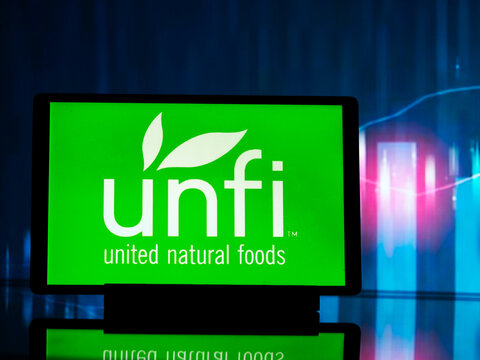 In this photo illustration,  United Natural Foods, Inc.  logo seen displayed on a tablet