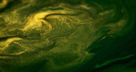 Glitter fluid texture. Shiny ink drip. Defocused green yellow color metallic golden sparkle grain...