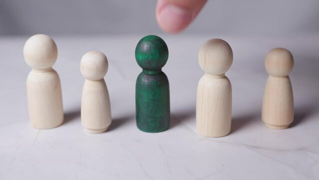 Picking up wooden figure best job candidate selection concept