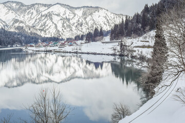 Panoramic Winter View Of Tadami Railway Line Train And Bridge Reflection In The Beautiful Valley Of...