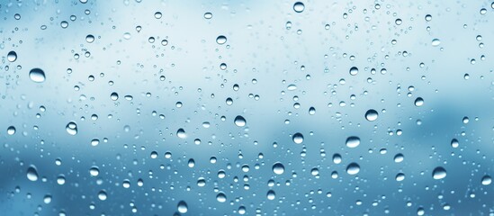 Water droplets from the rain are visible on a window glass, with a clear blue sky in the background creating a serene and refreshing scene