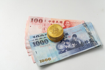 Taiwanese dollar banknote and Bitcoin