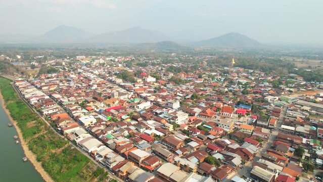 Aerial shot of rows of residential houses in Chiang Khan district alongside the Mekong Riverside in Thailand