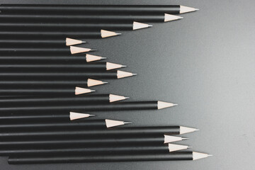 Black pencils on the matte black background. Minimal style. Conceptual minimalist black art.