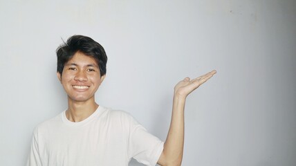 Excited young Asian man in white shirt with open palms