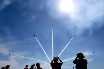 Jet planes flying by in formation at a show 