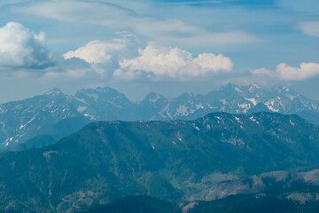 Fototapeta na wymiar Panoramic view of majestic mountain peaks of Julian Alps seen from on top of Feistritzer Spitze (Hochpetzen), Karawanks, Carinthia, border Austria Slovenia. Looking at unique rock formation Grintovec