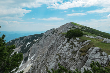 Panoramic view of mountain ridge Feistritzer Spitze (Hochpetzen), Carinthia, border Austria Slovenia. Alpine terrain of mountains Karawanks, Slovenian Austrian Alps. Hiking trail Petzen, Bleiburg