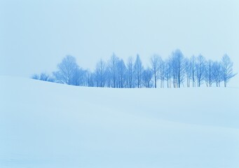 A snowy field with a few trees in the foreground