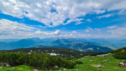 Fototapeta na wymiar On top of Feistritzer Spitze (Hochpetzen) with panoramic view of majestic mountain peaks Karawanks and Julian Alps, Carinthia, border Austria Slovenia. Hiking trail Petzen, Bleiburg, Völkermarkt