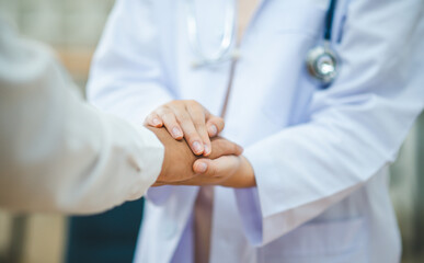 doctor hand holding the patient's hand. To encourage and comfort the patient so that the patient is not sad and worried.