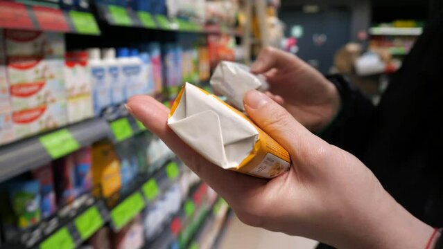 A customer chooses soap in a store.
