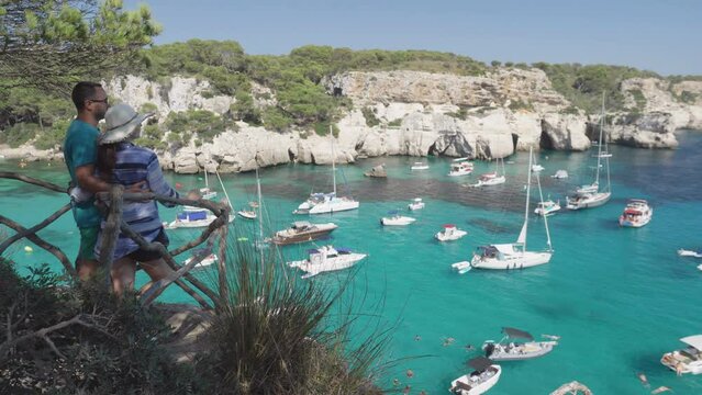 Young couple admiring the panorama of Cala Macarella in Menorca, Spain