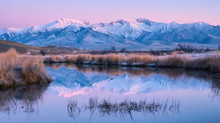 Gordijnen Snow-capped mountains reflect in tranquil waters at twilight with hues of purple and blue dominating the serene landscape. © kittikunfoto