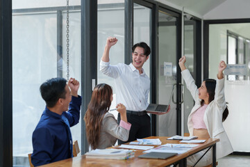 Great job! Successful business team is clapping their hands in modern workstation, celebrating the...