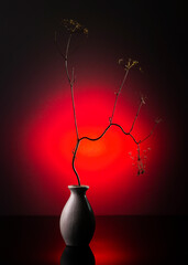 Modern still life with a dry branch in a vase on a bright background
