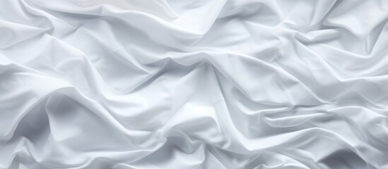 White sheet fabric showing abundant folds and creases up close, creating a textured surface