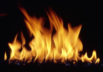 A fire is burning in the background of a black and white photo