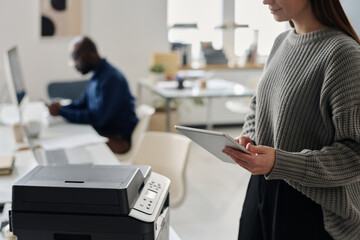 Unrecognizable Manager Using Digital Tablet And Printer - 773695948